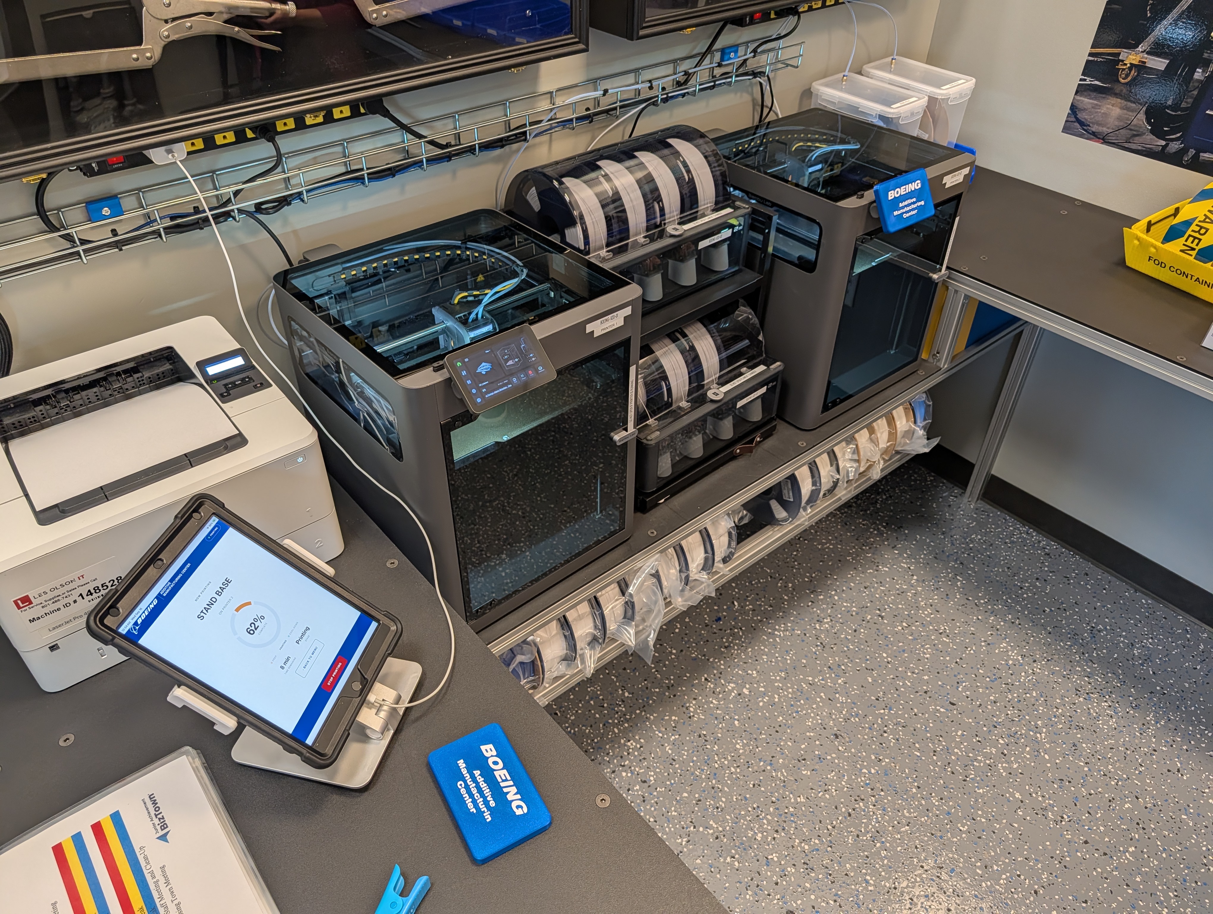 The Additive Manufacturing Center kiosk showing a print in progress beside the printer station