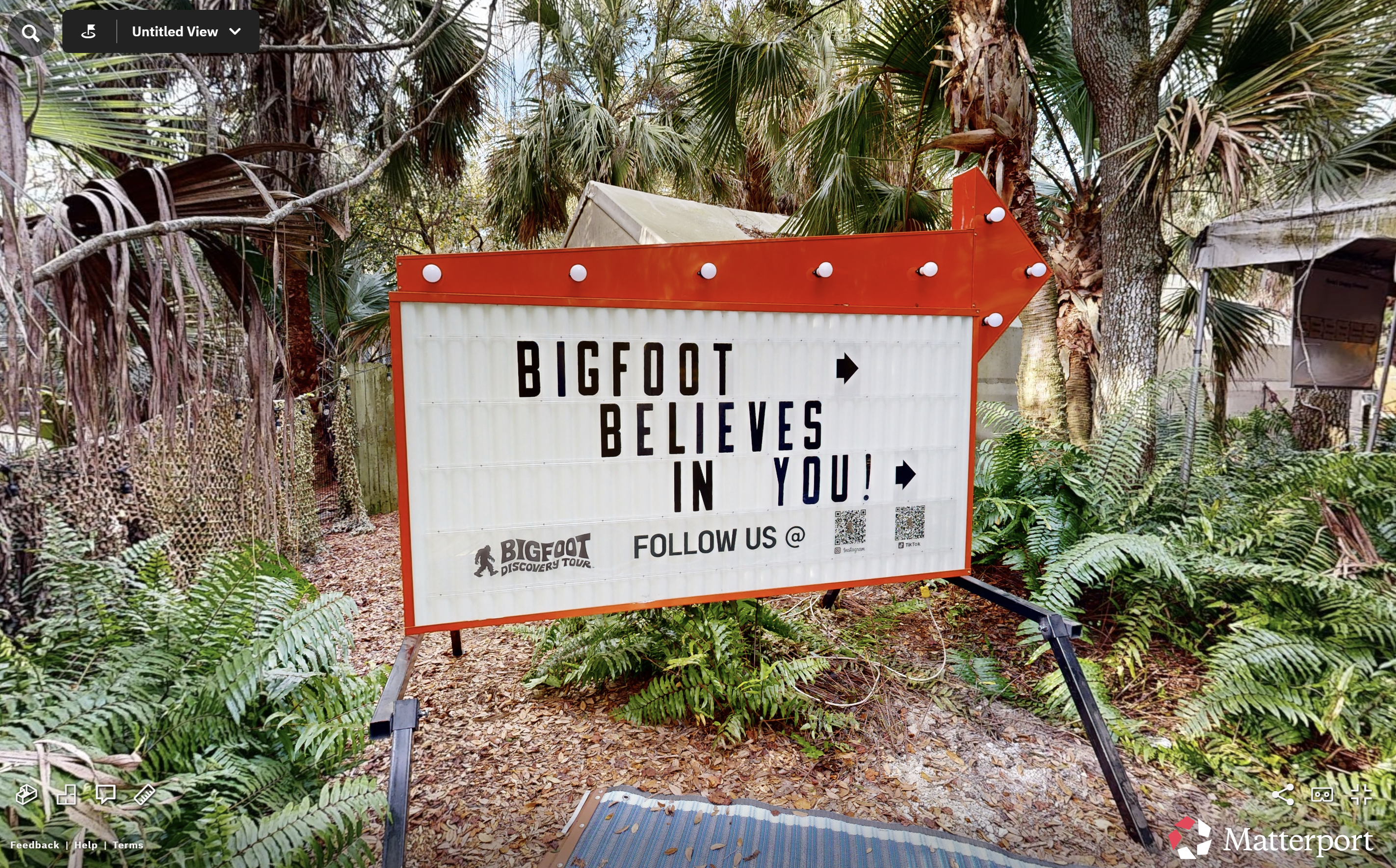 Bigfoot’s living room — a moss-draped vignette of leather, books, and woodland kitsch