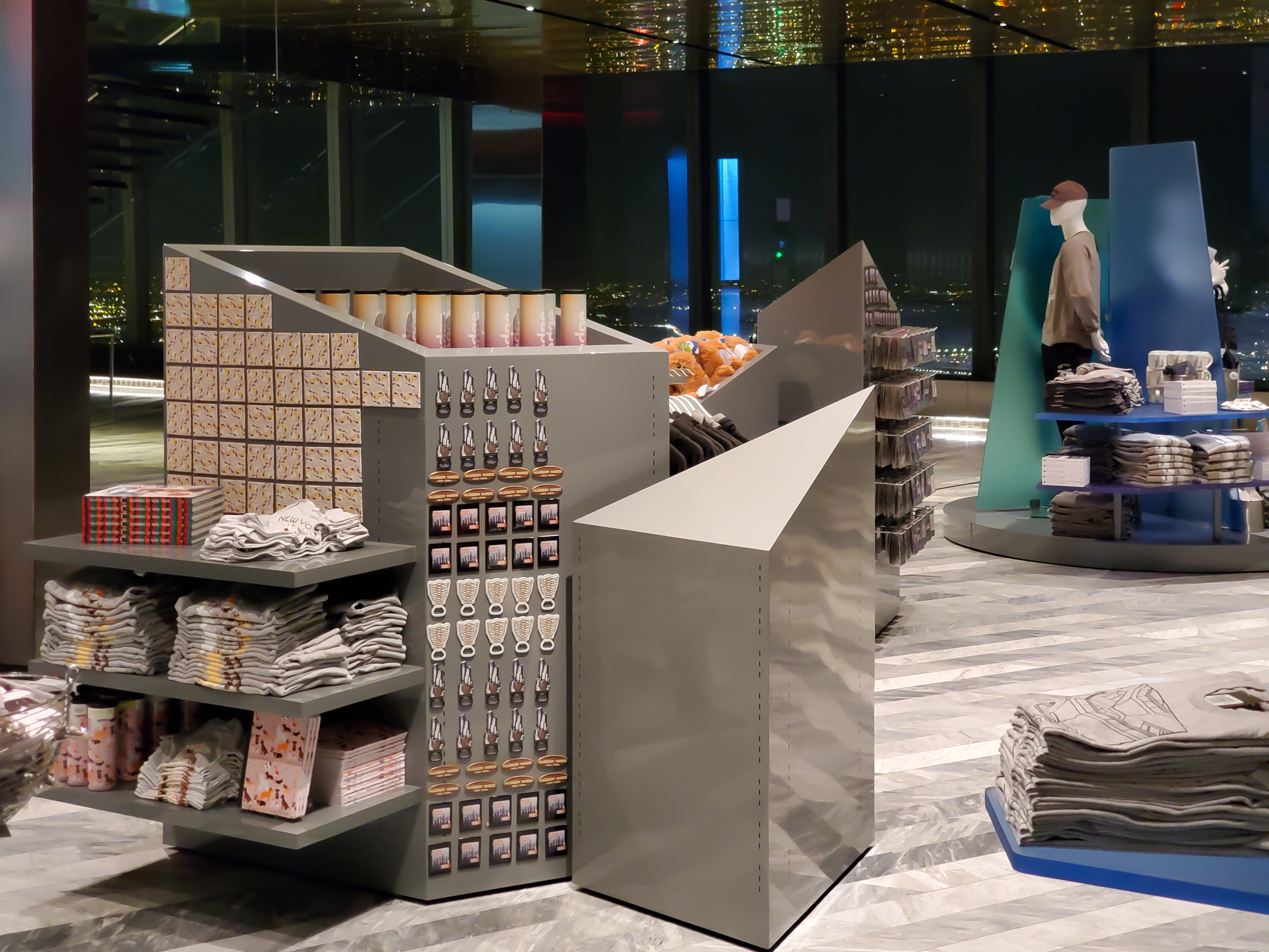 Skyline-inspired display towers set against the real thing through the glass