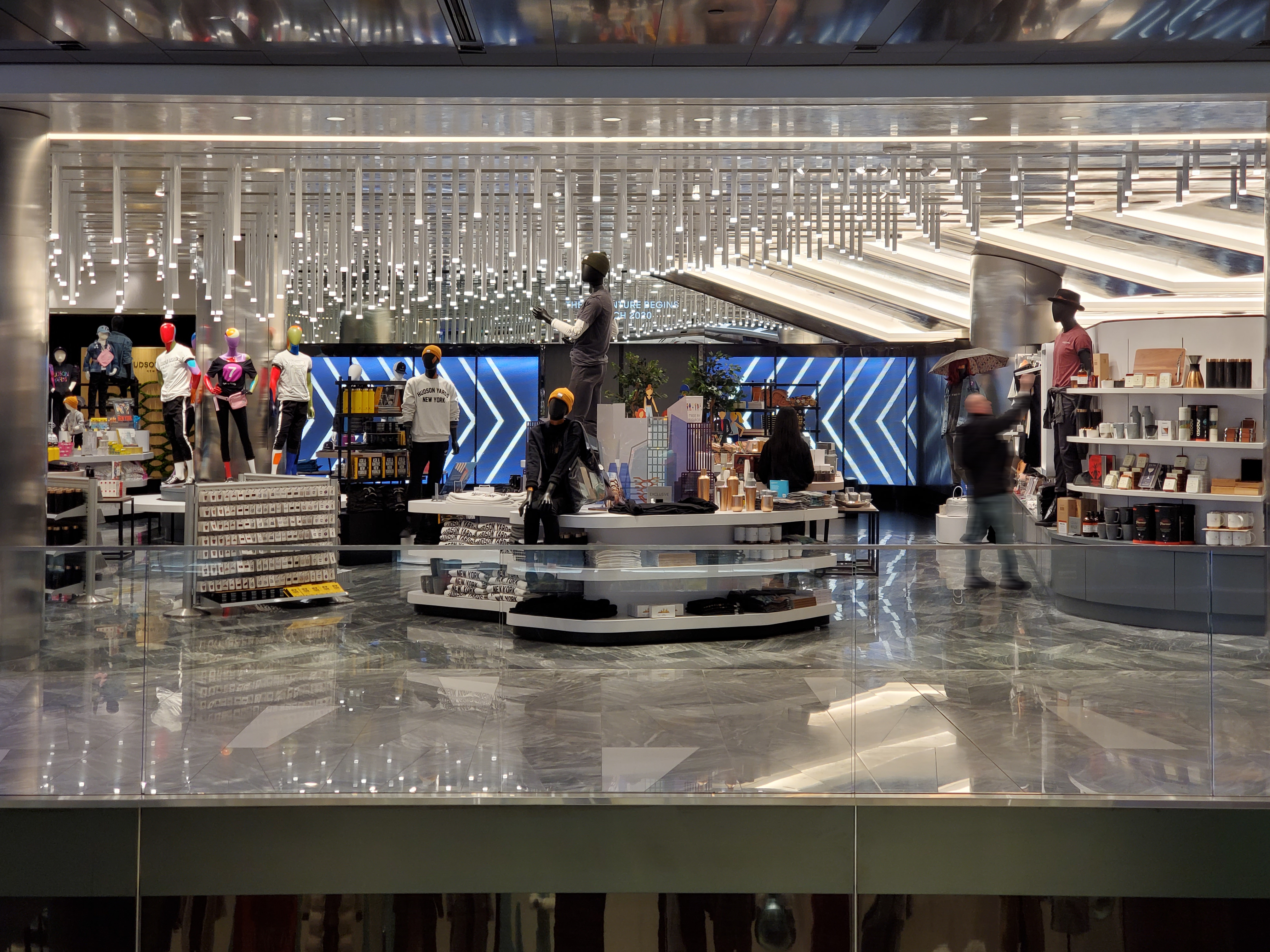 Cascading light rods and a mirror-polished ceiling float over the marble sales floor