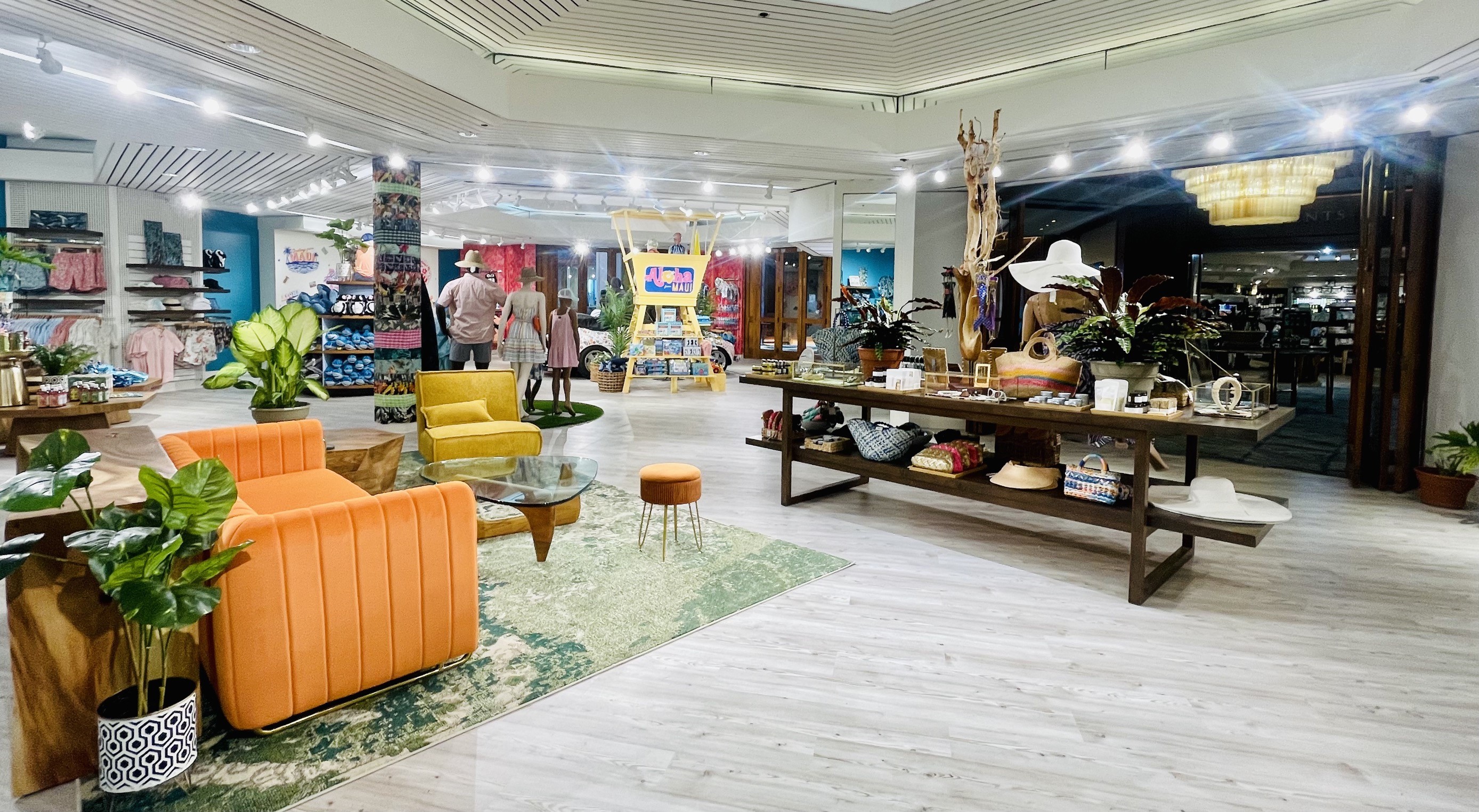 The sales floor from the cashwrap — the yellow “Aloha Maui” lifeguard tower anchoring the room